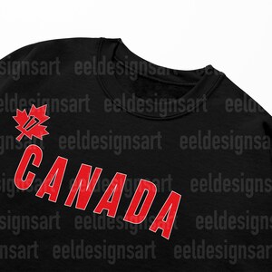 May include: Black sweatshirt with a red maple leaf and the word "CANADA" in red letters.