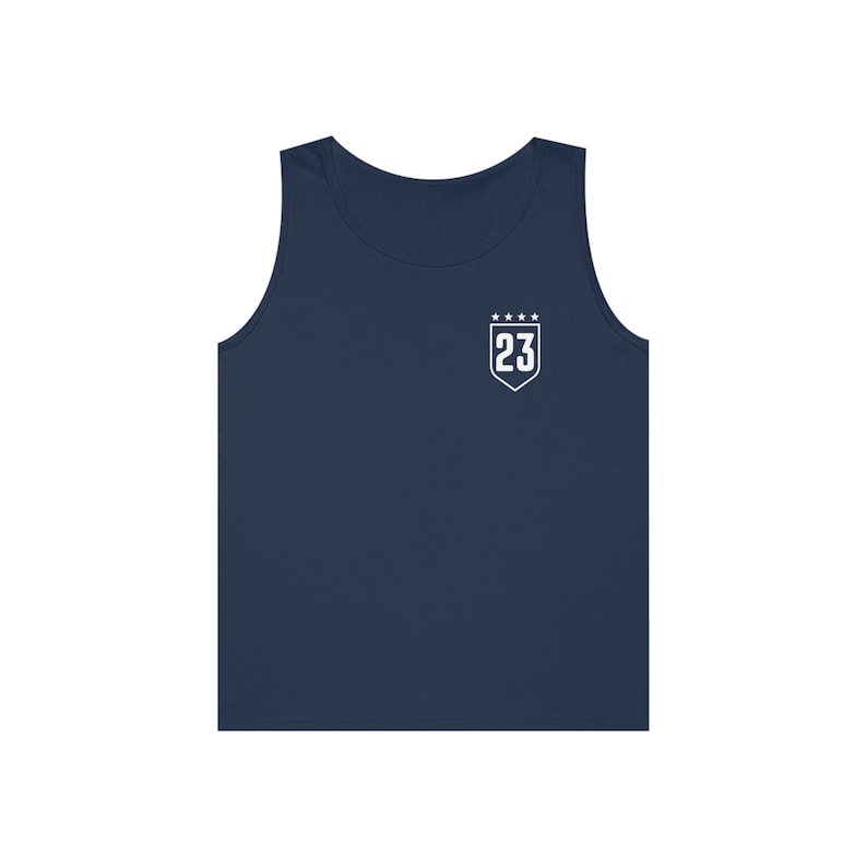 May include: A navy blue sleeveless tank top with a white shield-shaped patch featuring the number 23 and five stars.