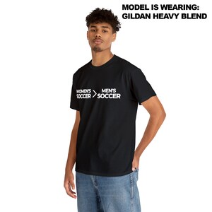 May include: Black t-shirt with white text that reads "Women's Soccer > Men's Soccer".