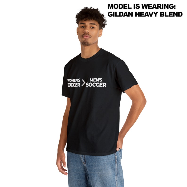 May include: Black t-shirt with white text that reads "Women's Soccer > Men's Soccer".