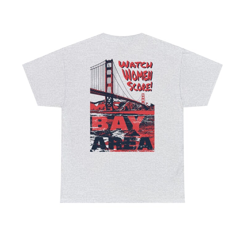 May include: A grey t-shirt with a red and blue graphic of the Golden Gate Bridge and the text "Watch Women Score! Bay Area".