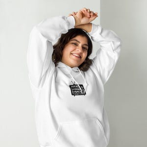 May include: A white hoodie with a black graphic of a television screen with the text "Watch Wong Score" on it.