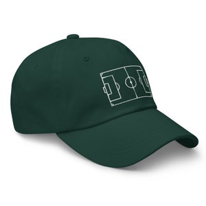 May include: A dark green baseball cap with a white embroidered outline of a football pitch.