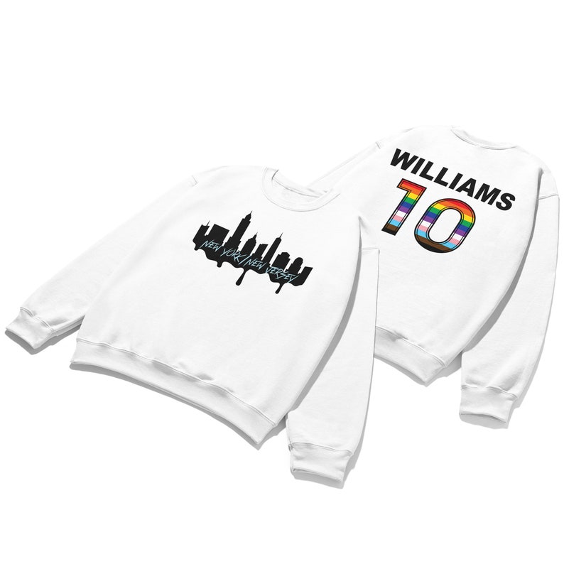 May include: White sweatshirt with a black silhouette of the New York City skyline and the text "NEW YORK/NEW JERSEY" on the front. The back of the sweatshirt has the text "WILLIAMS" and the number "10" in rainbow colors.