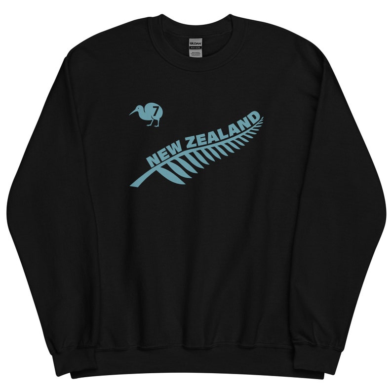 May include: Black sweatshirt featuring a blue kiwi bird and fern leaf design. The text "NEW ZEALAND" is printed on the fern leaf. The kiwi bird has the number "7" on it.