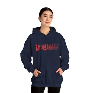 May include: A navy blue hooded sweatshirt with a red gradient graphic that says "BAY AREAAAAAAA"