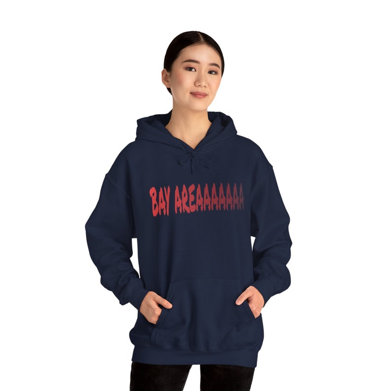 May include: A navy blue hooded sweatshirt with a red gradient graphic that says "BAY AREAAAAAAA"