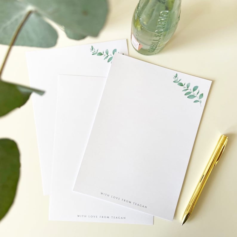 May include: Three white stationery note cards with a green leafy branch design and the text "With love from Teagan" at the bottom of each card.