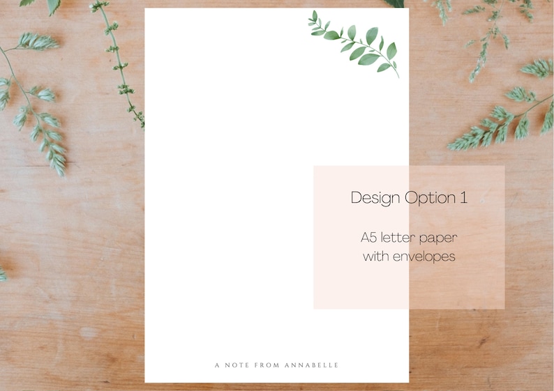 May include: A white card with a green leafy branch design in the top right corner. The card has the text "Design Option 1" and "A5 letter paper with envelopes" in black text. The card also has the text "A Note From Annabelle" at the bottom.