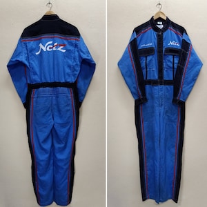 May include: Blue and black workwear jumpsuit with red stripes and the word "Netz" printed on the back.