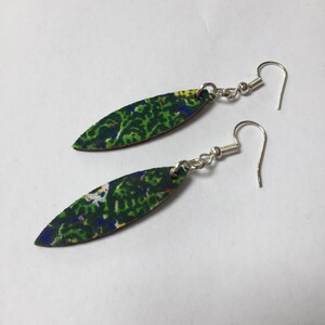 May include: A pair of green and blue fabric earrings with silver hooks. The fabric has a floral pattern.