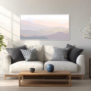 Mountain landscape wall art featuring layered mountain silhouettes in pastel tones and a contemporary minimalist style, presented as wall art framed in a natural wood floating frame.