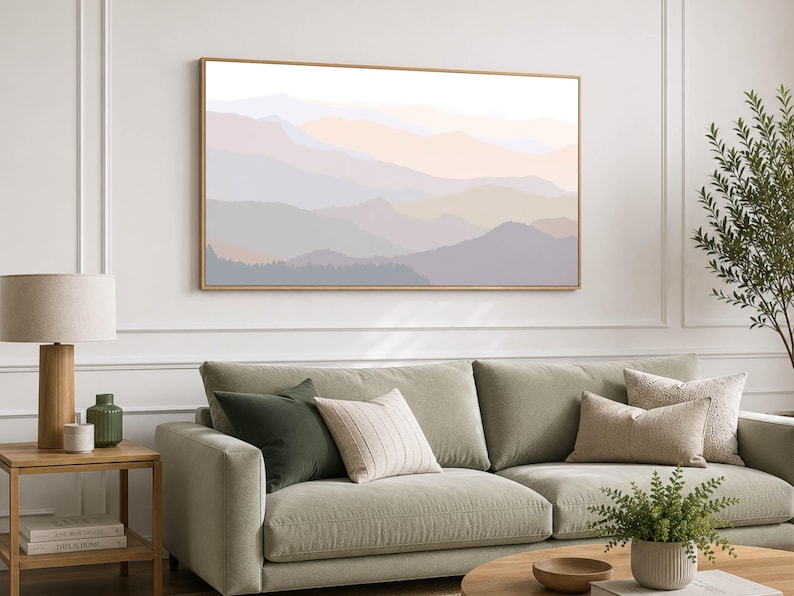 Bedroom wall art featuring layered pastel mountain ranges in soft blush, lavender, beige, and muted earth tones, presented as a large framed canvas with a natural wood floating frame.