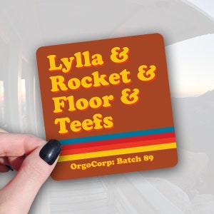 Sticker with text that says Lylla & Rocket & Floor & Teefs from the movie Guardians of the Galaxy.  With brown and yellow