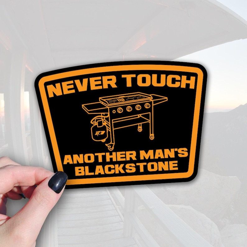 A sticker with the text NEVER TOUCH ANOTHER MANS BLACKSTONE and an illustration of a blackstone grill.