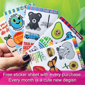 a person holding up a bunch of stickers