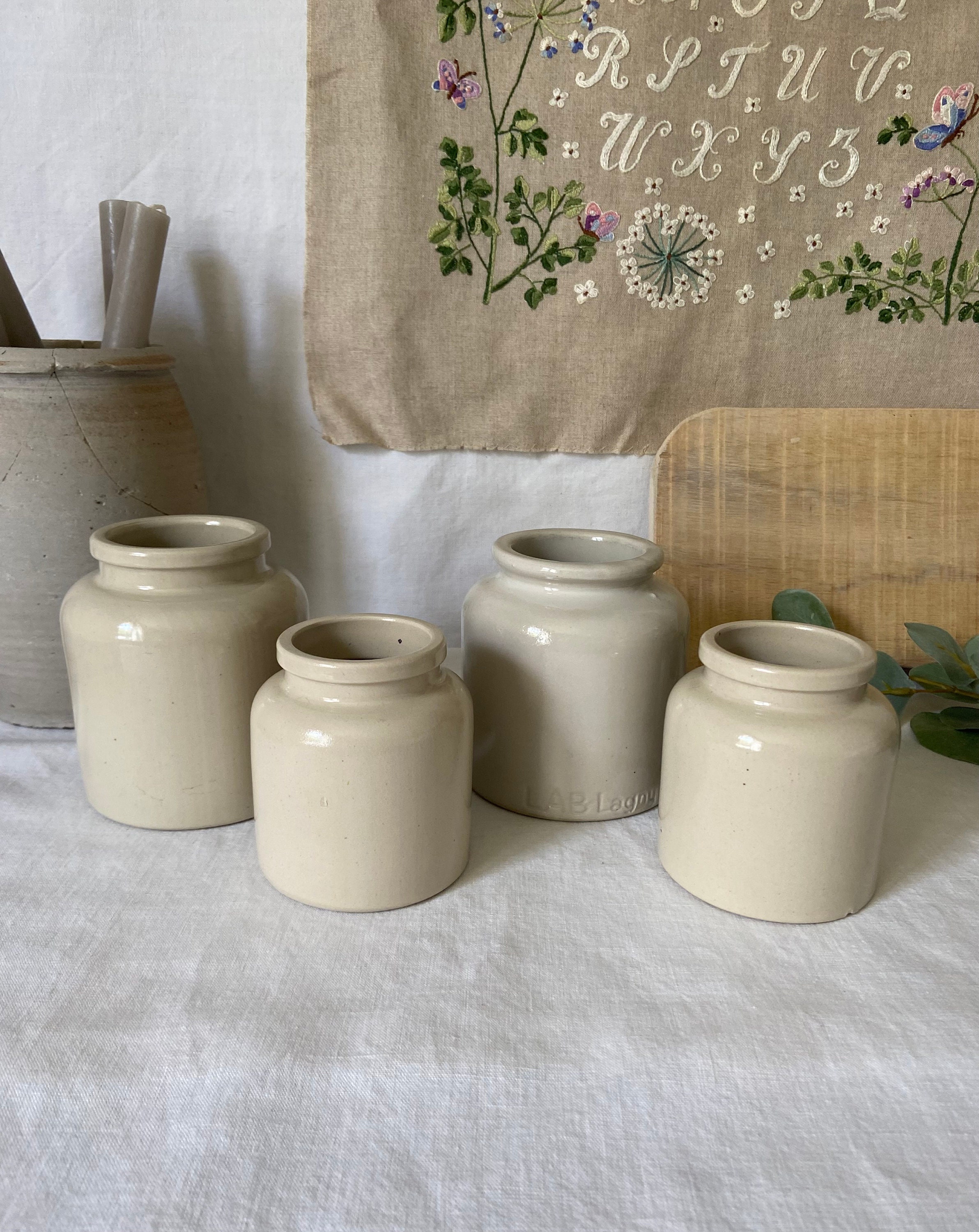Set of beige glazed stoneware pots. Antique French condiment pots.