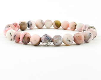 Könnte beinhalten: Ein Armband aus rosa und weißem Opal mit Perlenmuster.