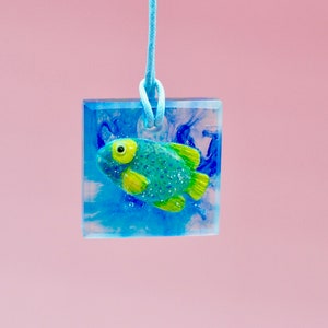Fish in the water sea sea creatures particularly colorful fish perch relatives blue yellow blue-fronted angelfish in resin Pendant on cotton cord