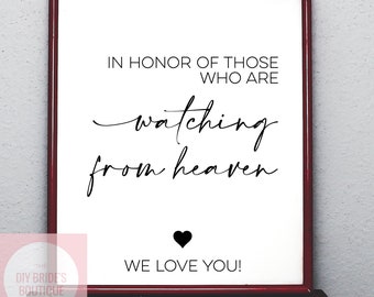 May include: A white framed print with black text that reads "In honor of those who are watching from heaven. We love you!" with a black heart symbol.