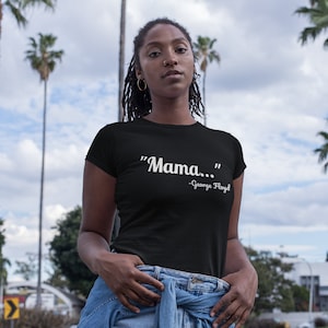 May include: A black t-shirt with the text "Mama..." and "George Floyd" printed in white.
