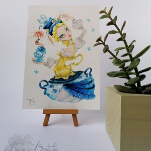 May include: A watercolor painting of a whimsical character wearing a teacup hat and holding a teapot. The character is surrounded by teacups and butterflies. The painting is on a small easel.