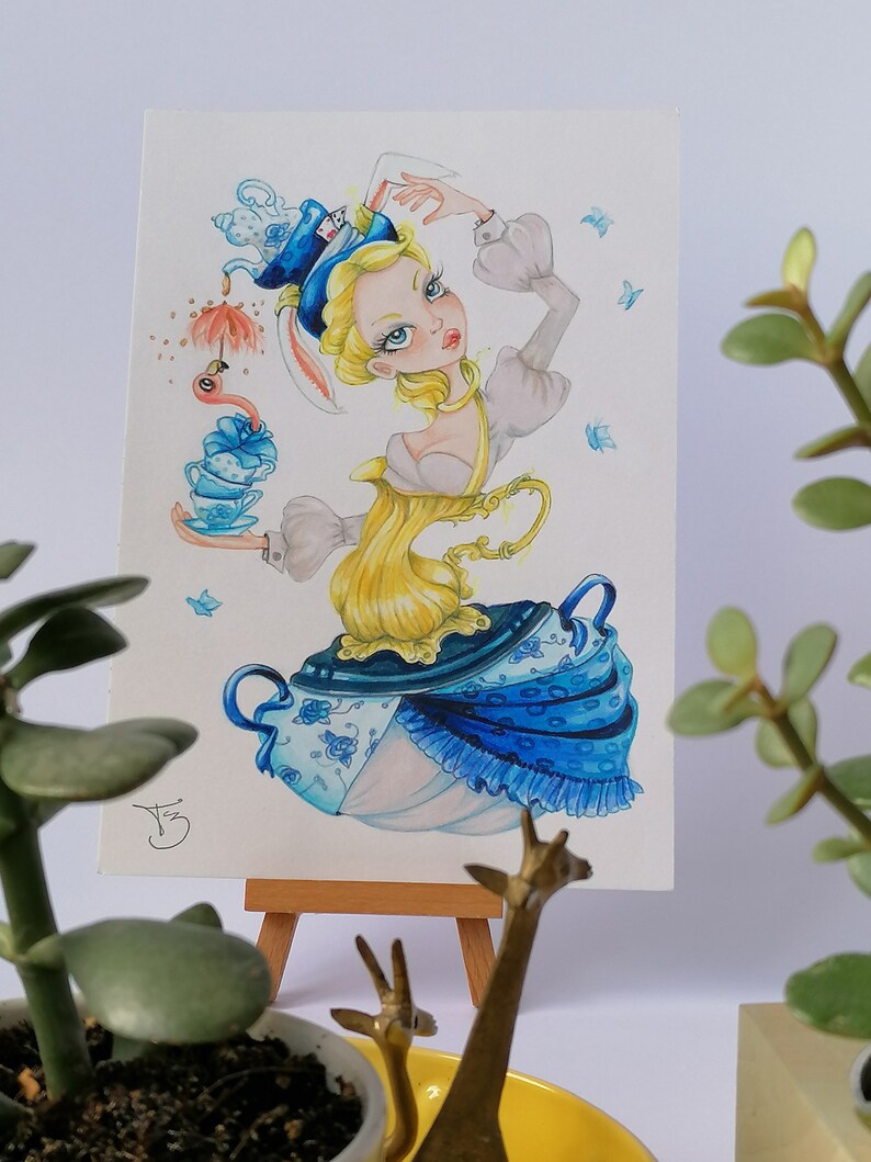 May include: A watercolor painting of a woman dressed in a blue and white teacup dress with a teapot hat. She is holding a teacup and saucer in her hand. The painting is set against a white background.