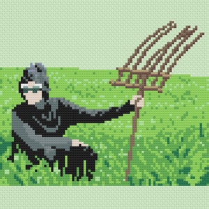 May include: A person wearing sunglasses and a black jacket sits in a field of green grass holding a brown rake.
