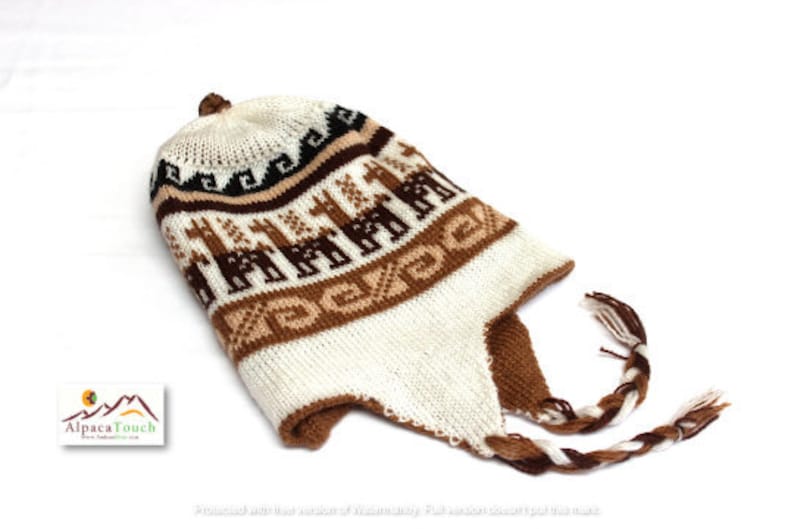 May include: A white, brown, and black knit hat with ear flaps and a braided tassel. The hat features a repeating pattern of brown llamas and geometric designs. The hat is made of a soft, warm material, perfect for cold weather.
