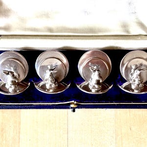 May include: A set of three ceramic mugs with a speckled, matte finish. The mugs are in shades of cream, light gray, and dark gray. Each mug has a simple, minimalist design, perfect for coffee or tea.