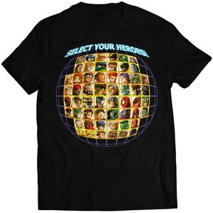 May include: Black t-shirt featuring a graphic of a grid of character portraits inside a globe. The text "SELECT YOUR HEROES!" is above the globe in a blue font. The shirt is made of a soft material.