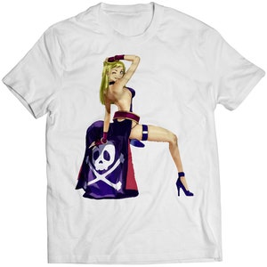 May include: White t-shirt with a colorful illustration of a woman in a purple and red pirate costume with a skull and crossbones on her skirt.