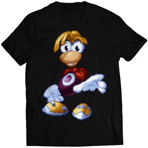 May include: Black t-shirt featuring a pixelated cartoon character with a red bow tie and a purple orb. The character has blonde hair and is wearing white gloves.