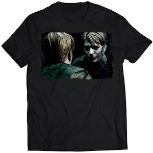 May include: Black t-shirt featuring a graphic print of a man looking into a mirror. The man in the reflection has a darker, more sinister appearance.