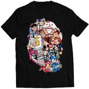 Könnte beinhalten: Ein schwarzes T-Shirt mit einer bunten Cartoon-Illustration einer Gruppe von Figuren, die ein Videospiel spielen. Die Figuren sind alle in verschiedenen Farben gehalten und haben unterschiedliche Gesichtsausdrücke. Das Videospiel ist eine Handheld-Konsole mit einem Bildschirm und Knöpfen.