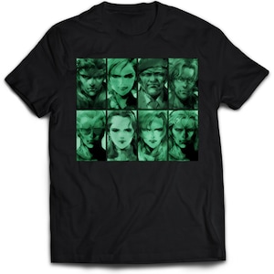 Op de afbeelding: Zwart T-shirt met een groene gepixelde afbeelding van acht personages uit een videogame. De personages zijn gerangschikt in een raster van vier rijen en twee kolommen.