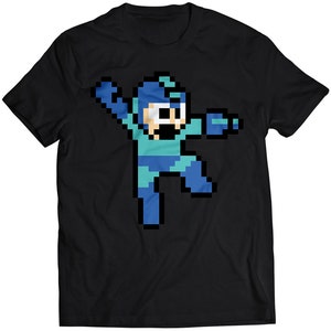 Puede incluir: Camiseta negra con un personaje de videojuego pixelado azul y verde con casco.