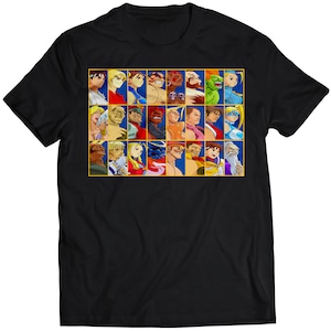 Op de afbeelding: Zwart T-shirt met een kleurrijke afbeelding van personages uit de Street Fighter-videogameserie. De personages zijn in een rasterpatroon gerangschikt en worden afgebeeld in hun kenmerkende poses.