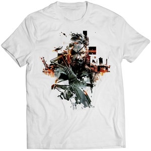 May include: White t-shirt featuring a graphic print of a man with a bandana and eyepatch holding a rifle. The graphic is in a stylised, abstract style with splashes of colour.