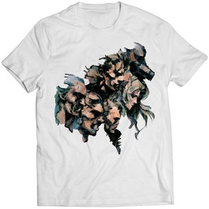 May include: A white t-shirt with a black and white graphic print of five faces. The faces are drawn in a stylized, abstract style. The graphic is centered on the shirt.