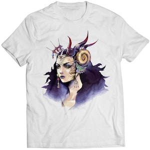 May include: White t-shirt featuring a colourful illustration of a woman with horns and a crown. The woman has purple hair and is wearing jewellery.