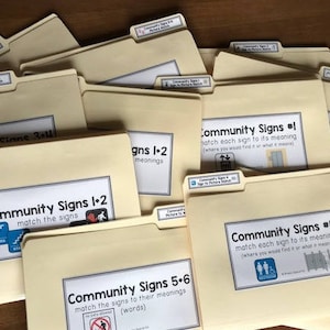 May include: A stack of yellow folders with the title "Community Signs" and numbers 1-6. Each folder has a different sign and instructions to match the sign to its meaning.