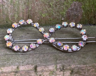 Preowned infinity barrette with lovely rhinestones in changing colors