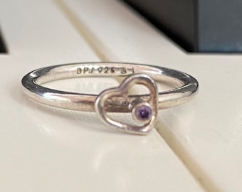 Preowned silver spinner ring with heart and small purple stone