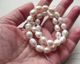 35+ 8-9mm AA + Strand of white freshwater pearls, irregular oval shapes. TIA-129