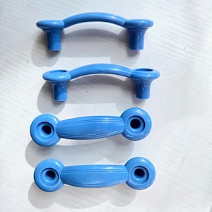 May include: Four blue plastic cabinet knobs with a rounded, arched design. The knobs are arranged vertically in a row.