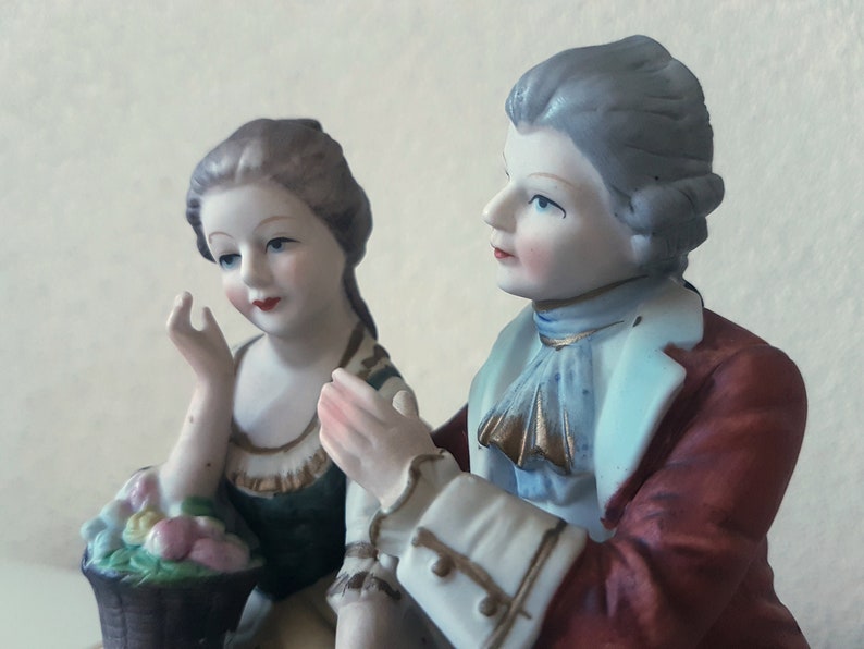 Large vintage porcelain figurine young Couple with flowers sitting on a rock