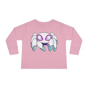Könnte beinhalten: Rosa Langarm-Shirt für Kleinkinder mit einer weißen Cartoon-Spinne mit blauen Beinen und violetten Augen.