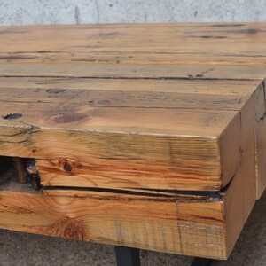 Pu&ograve; includere: Un tavolino da caff&egrave; in legno rustico con una finitura in legno naturale. Il tavolo &egrave; realizzato in legno riciclato e ha un aspetto unico e artigianale. Il tavolo &egrave; sostenuto da una struttura in metallo nero.