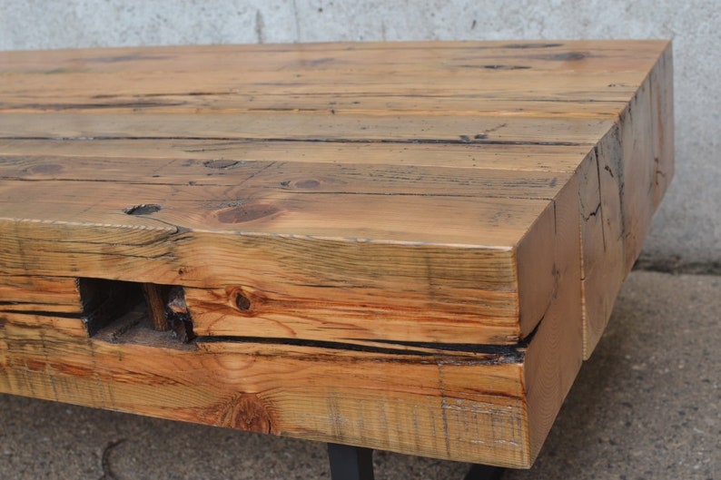 Pu&ograve; includere: Un tavolino da caff&egrave; in legno rustico con una finitura in legno naturale. Il tavolo &egrave; realizzato in legno riciclato e ha un aspetto unico e artigianale. Il tavolo &egrave; sostenuto da una struttura in metallo nero.